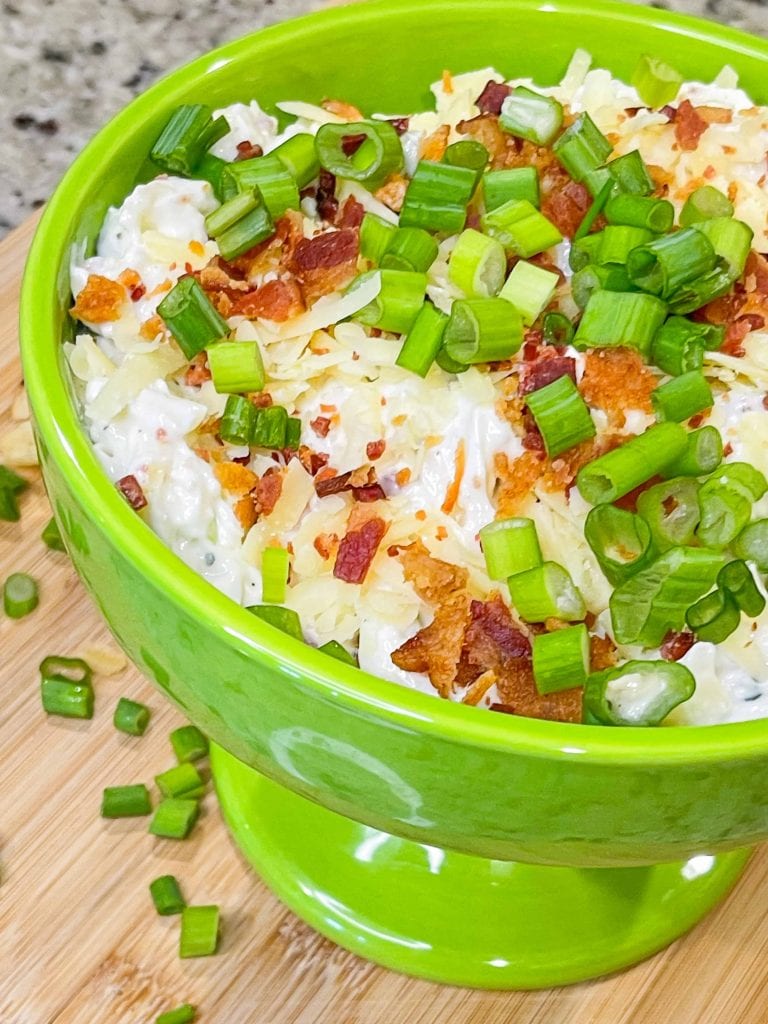 Loaded chip dip is an easy and quick dip recipe made with sour cream, cream cheese, crispy bacon, cheddar cheese, ranch seasoning and green onion that’s perfect for a party, tailgate, or any night of the week and is ready in less than 20 minutes.