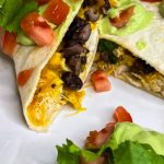 this healthy, high protein chicken quesadilla starts with juicy air fried chicken breast easily cooked to perfection in the Cosori air fryer, then it's shredded and add to a low carb tortilla with cheddar cheese and fiber rich black beans, making it the perfect meal.