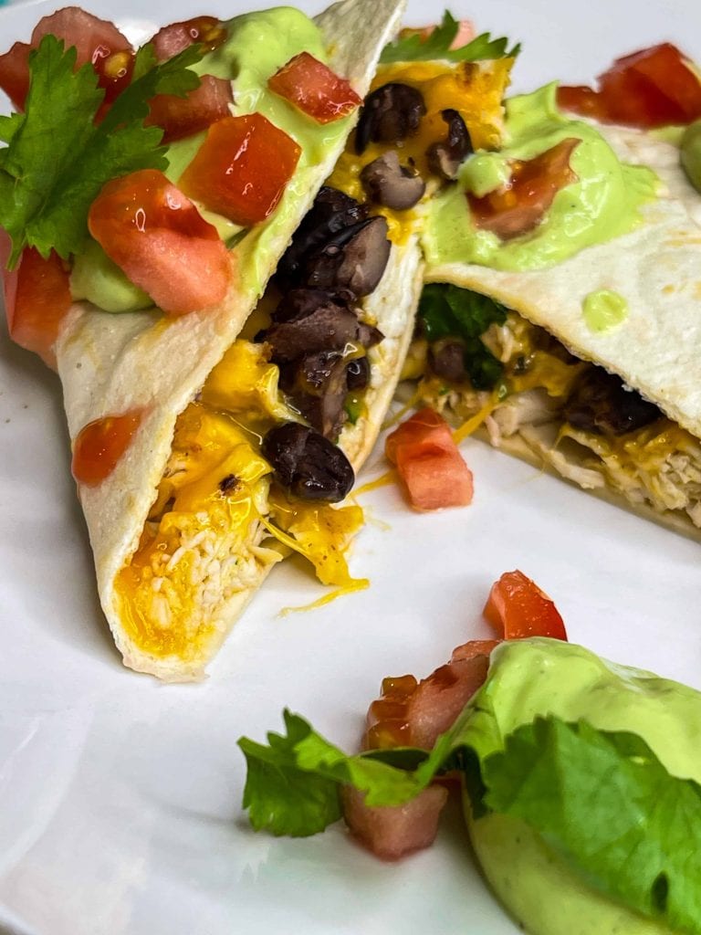 this healthy, high protein chicken quesadilla starts with juicy air fried chicken breast easily cooked to perfection in the Cosori air fryer, then it's shredded and add to a low carb tortilla with cheddar cheese and fiber rich black beans, making it the perfect meal.