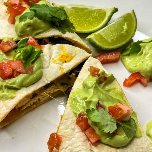 this healthy, high protein chicken quesadilla starts with juicy air fried chicken breast easily cooked to perfection in the Cosori air fryer, then it's shredded and add to a low carb tortilla with cheddar cheese and fiber rich black beans, making it the perfect meal.