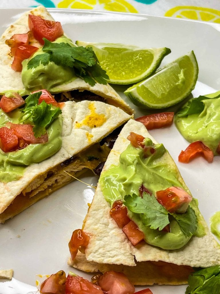 this healthy, high protein chicken quesadilla starts with juicy air fried chicken breast easily cooked to perfection in the Cosori air fryer, then it's shredded and add to a low carb tortilla with cheddar cheese and fiber rich black beans, making it the perfect meal.