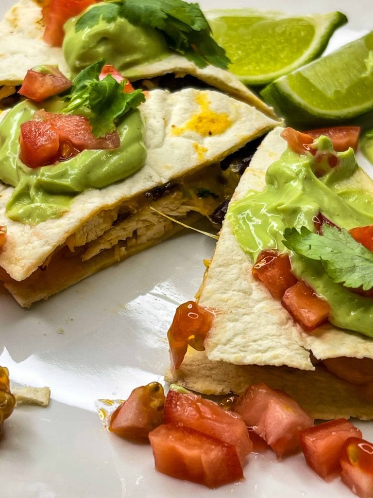 this healthy, high protein chicken quesadilla starts with juicy air fried chicken breast easily cooked to perfection in the Cosori air fryer, then it's shredded and add to a low carb tortilla with cheddar cheese and fiber rich black beans, making it the perfect meal.