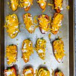 Boursin Cheese Pepper Poppers are my go-to snack to make for game day! Mini sweet peppers are stuffed with savory Boursin cheese and sharp cheddar cheese, baked until gooey, and topped with crisp bacon and bright green onions for the perfect cheesy bite.