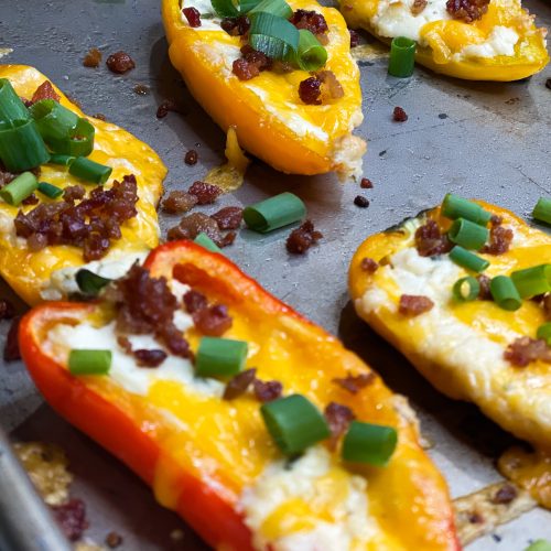 Boursin Cheese Pepper Poppers are my go-to snack to make for game day! Mini sweet peppers are stuffed with savory Boursin cheese and sharp cheddar cheese, baked until gooey, and topped with crisp bacon and bright green onions for the perfect cheesy bite.