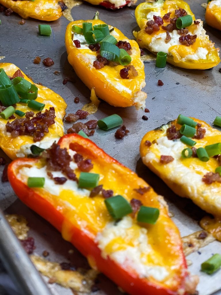 Boursin Cheese Pepper Poppers are my go-to snack to make for game day! Mini sweet peppers are stuffed with savory Boursin cheese and sharp cheddar cheese, baked until gooey, and topped with crisp bacon and bright green onions for the perfect cheesy bite. 