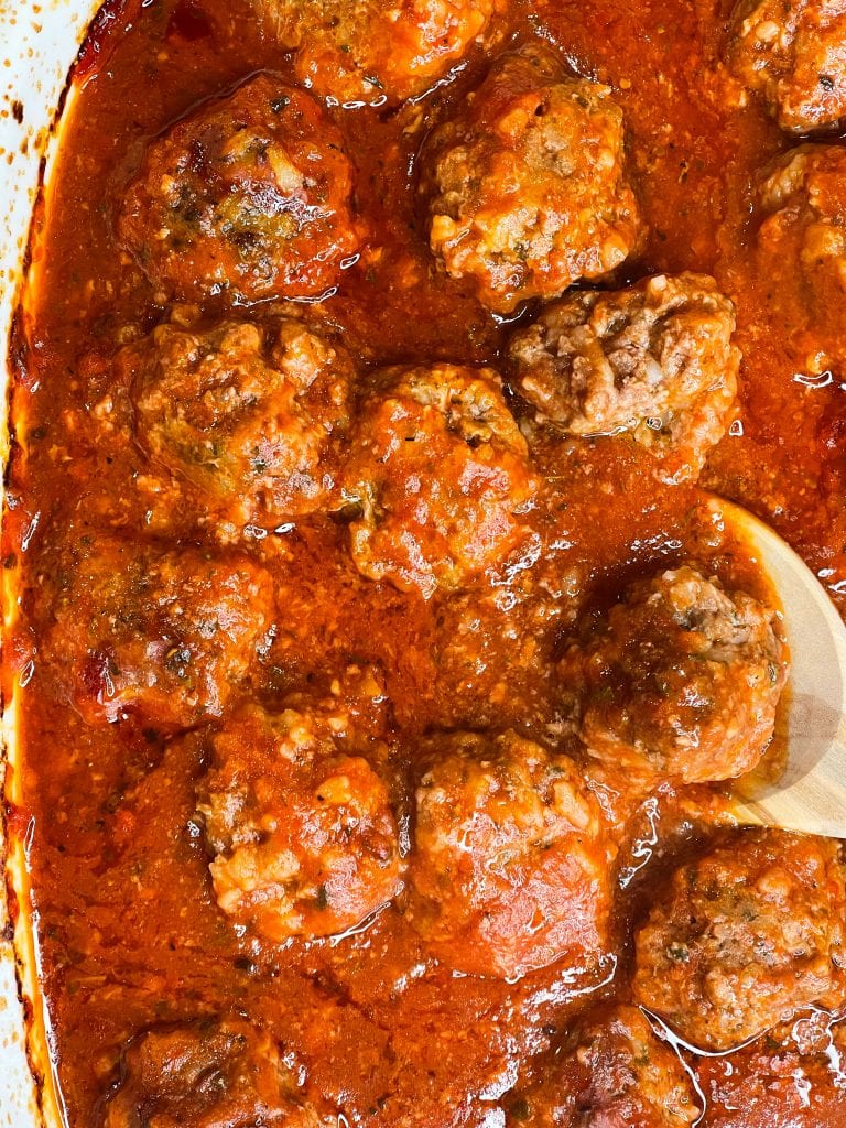 Porcupine meatballs are juicy and tender meatballs made with rice, ground beef, and seasonings in a tangy tomato sauce, all baked in one dish in the oven. These scrumptious meatballs are easy, kid friendly and a perfect weeknight dinner served alongside mashed potatoes and your favorite vegetables. #easydinner #meatballs #kidfriendy #Stephgigliotti #onedishmeal