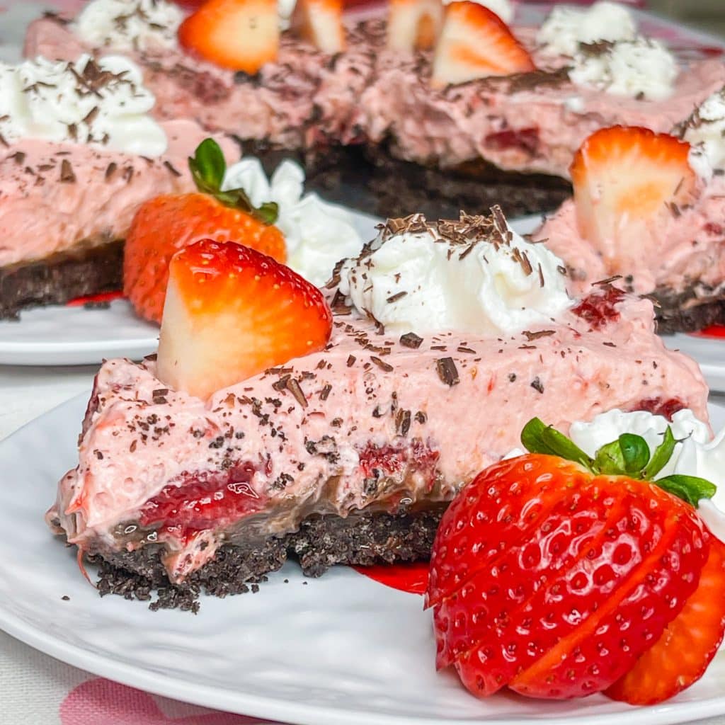 Chocolate Covered strawberry pie is a luscious no bake dessert with an Oreo crust, a layer of fudge and a creamy strawberry filling. Perfect for Valentine's day or any party or holiday. 