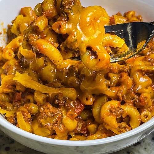 Old Fashioned American Goulash is an easy 30 minute meal, cooked in one pot with macaroni, tomato sauce, and ground beef. It's hearty and delicious and a quick weeknight dinner.