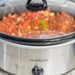 Slow Cooker Chili is hearty and warming, a little spicy, and the perfect dish to serve for game day. Beef and bacon slow cook all day with tomatoes, onions, peppers, and a homemade spice blend for a deeply flavorful soup. Add your favorite toppings for a crowd pleasing and easy bowl of meaty chili.