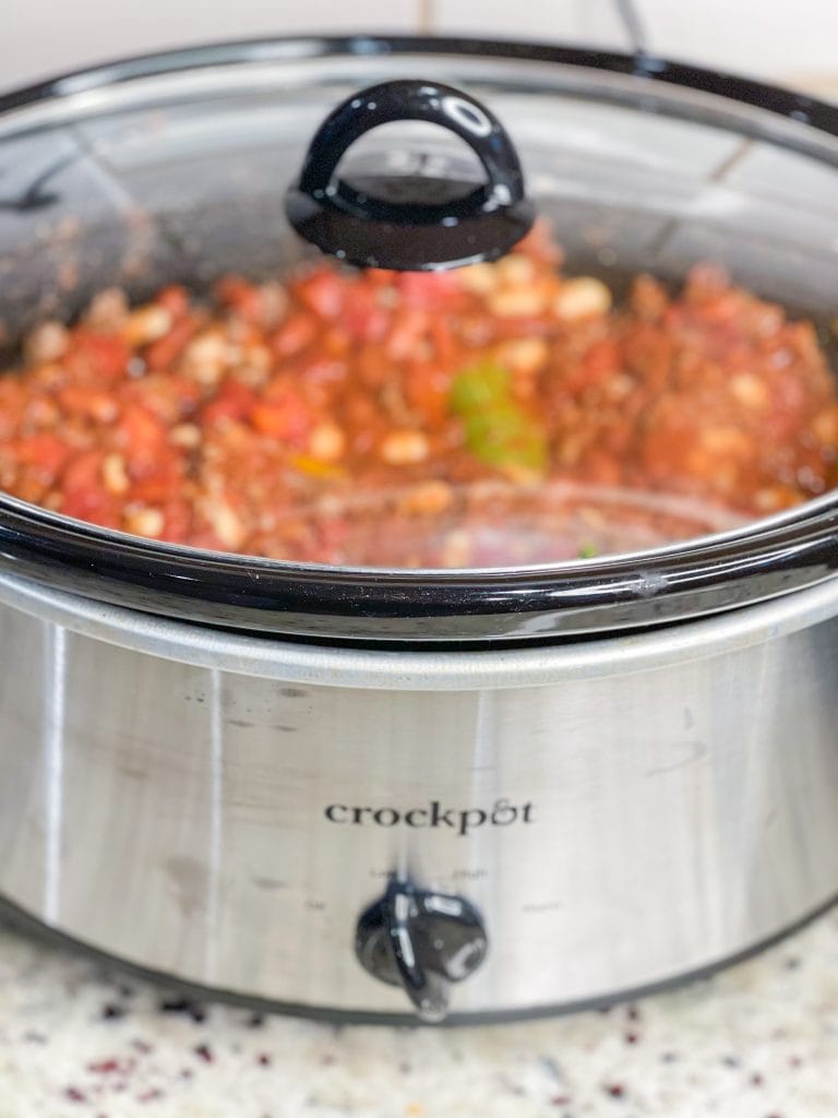 Slow Cooker Chili is hearty and warming, a little spicy, and the perfect dish to serve for game day. Beef and bacon slow cook all day with tomatoes, onions, peppers, and a homemade spice blend for a deeply flavorful soup. Add your favorite toppings for a crowd pleasing and easy bowl of meaty chili.