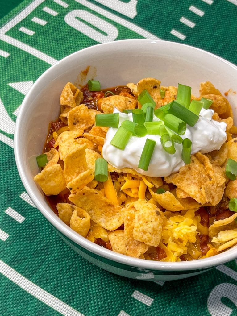 Slow Cooker Chili is hearty and warming, a little spicy, and the perfect dish to serve for game day. Beef and bacon slow cook all day with tomatoes, onions, peppers, and a homemade spice blend for a deeply flavorful soup. Add your favorite toppings for a crowd pleasing and easy bowl of meaty chili.