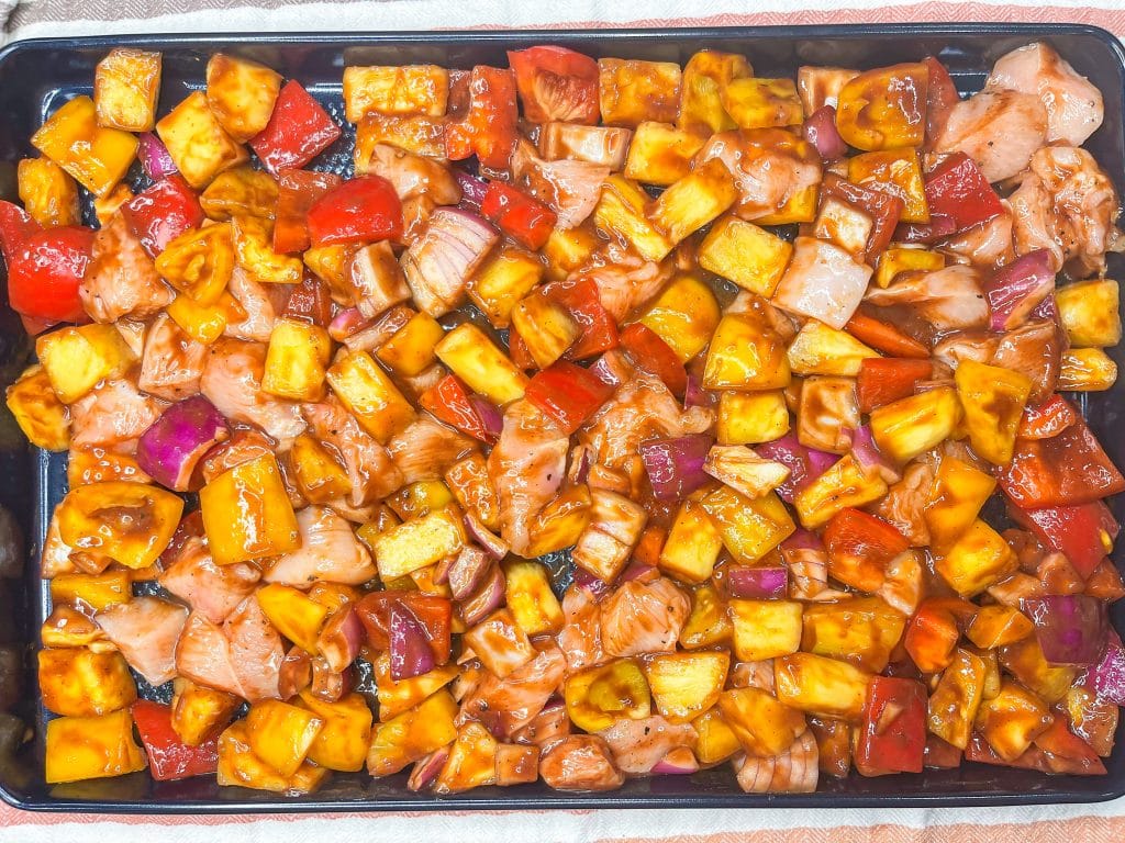 30 minutes easy sheet pan pineapple BBQ chicken with peppers and onions is the perfect weeknight family friendly dinner!