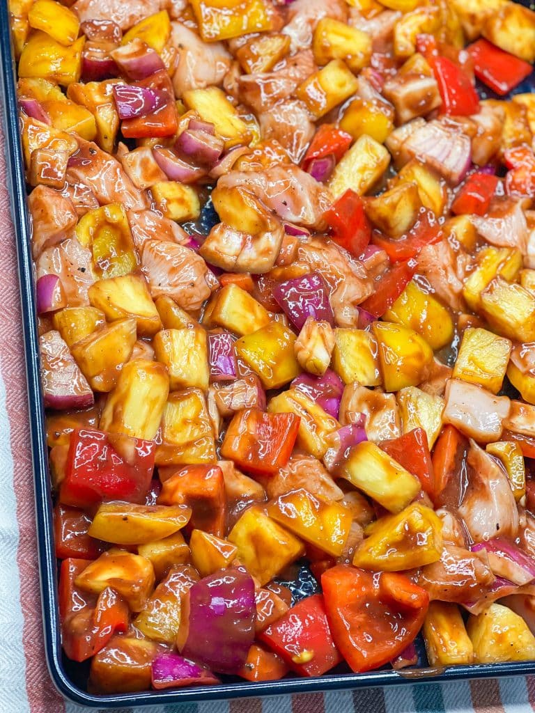 30 minutes easy sheet pan pineapple BBQ chicken with peppers and onions is the perfect weeknight family friendly dinner!