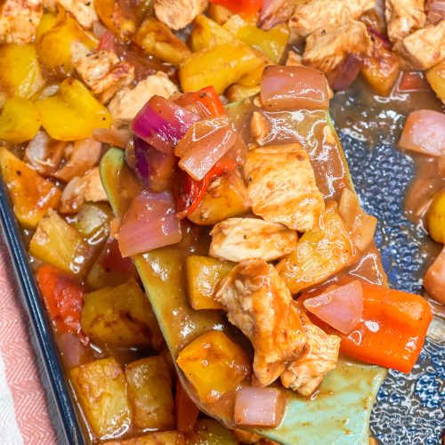 30 minutes easy sheet pan pineapple BBQ chicken with peppers and onions is the perfect weeknight family friendly dinner!