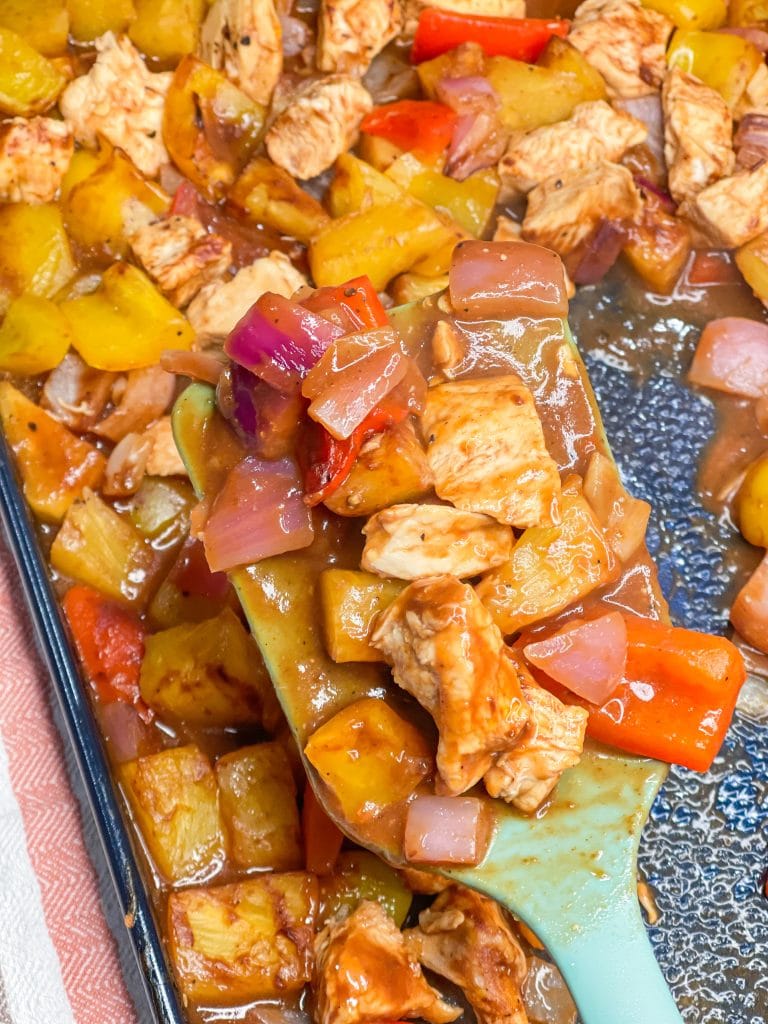 30 minutes easy sheet pan pineapple BBQ chicken with peppers and onions is the perfect weeknight family friendly dinner!