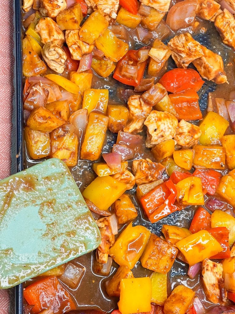 30 minutes easy sheet pan pineapple BBQ chicken with peppers and onions is the perfect weeknight family friendly dinner!