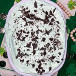 Andes Mint Poke Cake is a fudgy chocolate cake topped with a minty whipped cream and Andes mint candies. This easy poke cake is perfect for St Patrick's Day or for anyone who loves mint!