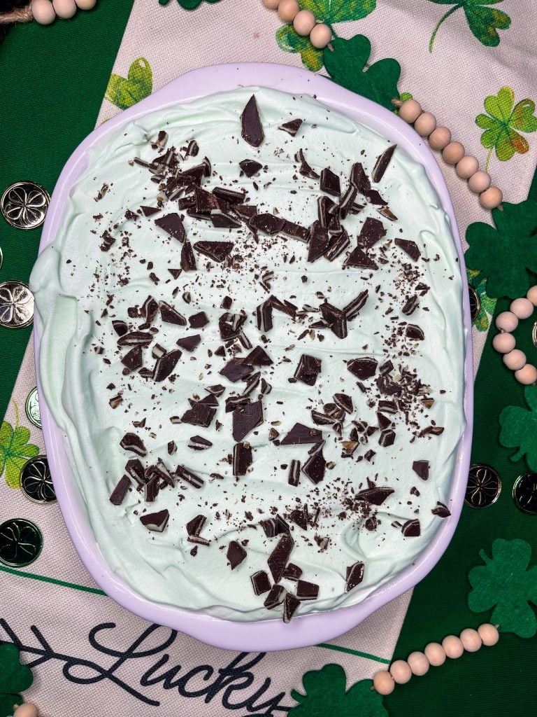 Andes Mint Poke Cake is a fudgy chocolate cake topped with a minty whipped cream and Andes mint candies. This easy poke cake is perfect for St Patrick's Day or for anyone who loves mint!