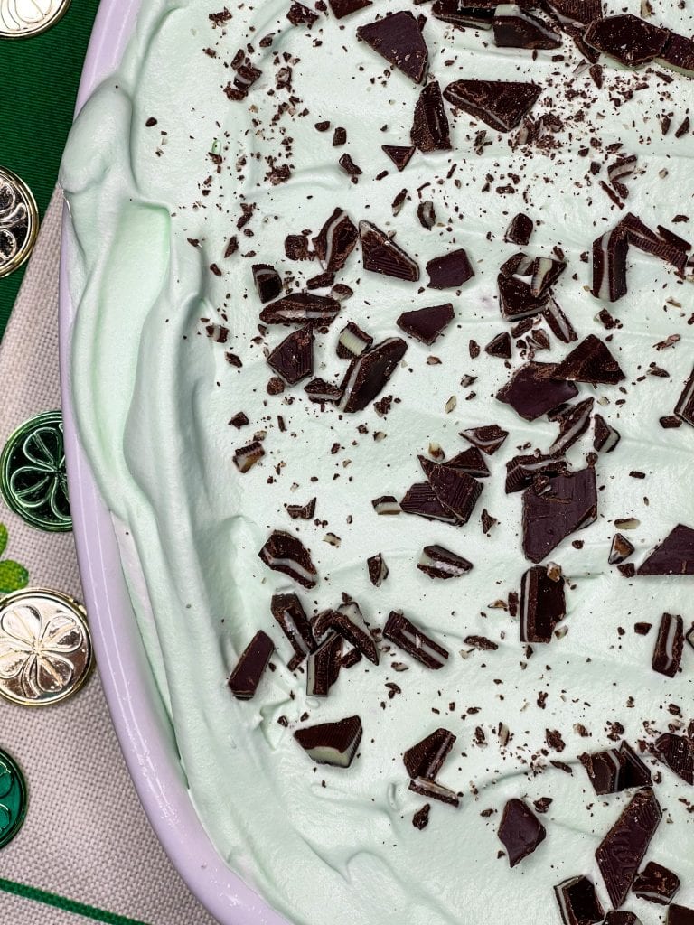 Andes Mint Poke Cake is a fudgy chocolate cake topped with a minty whipped cream and Andes mint candies. This easy poke cake is perfect for St Patrick's Day or for anyone who loves mint!