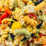 This pasta salad is a combination of rotini pasta, chunky cheeses, veggies zesty Italian dressing and seasoning is just amazing! Great for any get-together or summer picnic.