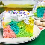 This colorful Easter Poke Cake is sure to delight on your Easter table! This cake is so easy to prepare but looks like an absolute show stopper. All you need is a box of cake mix, food coloring, pudding mix and cool whip for the brightest dessert to WOW your guests.