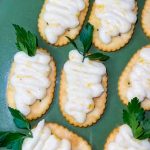 These Peach Jam Easter Appetizers are not only adorable, but delicious too! Simply pipe the peach filling on a cracker in the shape of a carrot, add a sprig of parsley and you have the easiest appetizer for your Easter buffet.