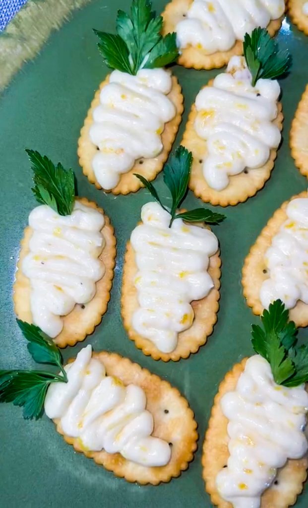 These Peach Jam Easter Appetizers are not only adorable, but delicious too! Simply pipe the peach filling on a cracker in the shape of a carrot, add a sprig of parsley and you have the easiest appetizer for your Easter buffet.