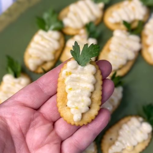 These Peach Jam Easter Appetizers are not only adorable, but delicious too! Simply pipe the peach filling on a cracker in the shape of a carrot, add a sprig of parsley and you have the easiest appetizer for your Easter buffet.