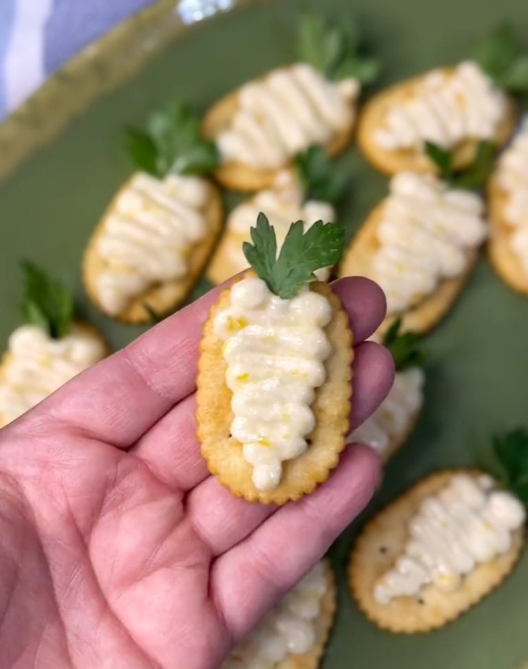 These Peach Jam Easter Appetizers are not only adorable, but delicious too! Simply pipe the peach filling on a cracker in the shape of a carrot, add a sprig of parsley and you have the easiest appetizer for your Easter buffet.