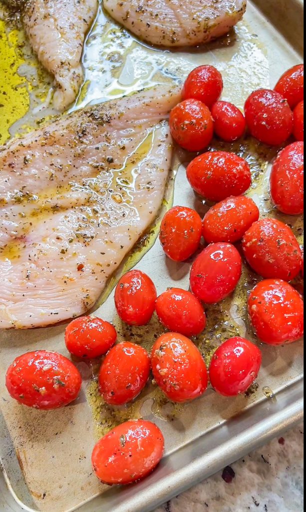 Love sheet pan dinners? This is for you! Sheet Pan Italian Style Chicken is super easy and super flavorful. Sweet roasted tomatoes top juicy, cheesy chicken and it's finished off with fresh herbs and a drizzle of balsamic vinegar. The perfect week night meal.