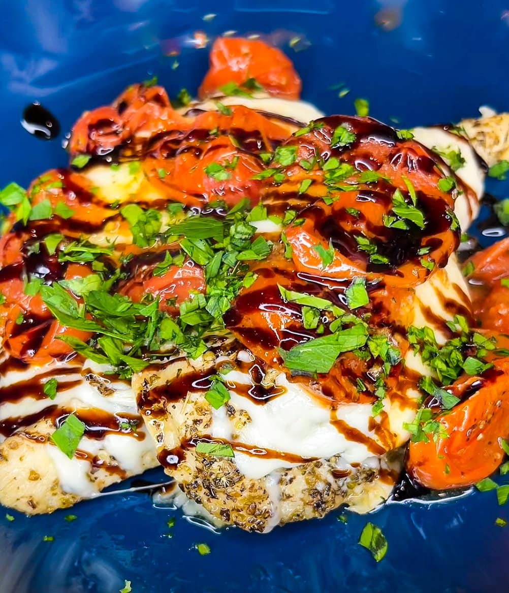 Love sheet pan dinners? This is for you! Sheet Pan Italian Style Chicken is super easy and super flavorful. Sweet roasted tomatoes top juicy, cheesy chicken and it's finished off with fresh herbs and a drizzle of balsamic vinegar. The perfect week night meal.