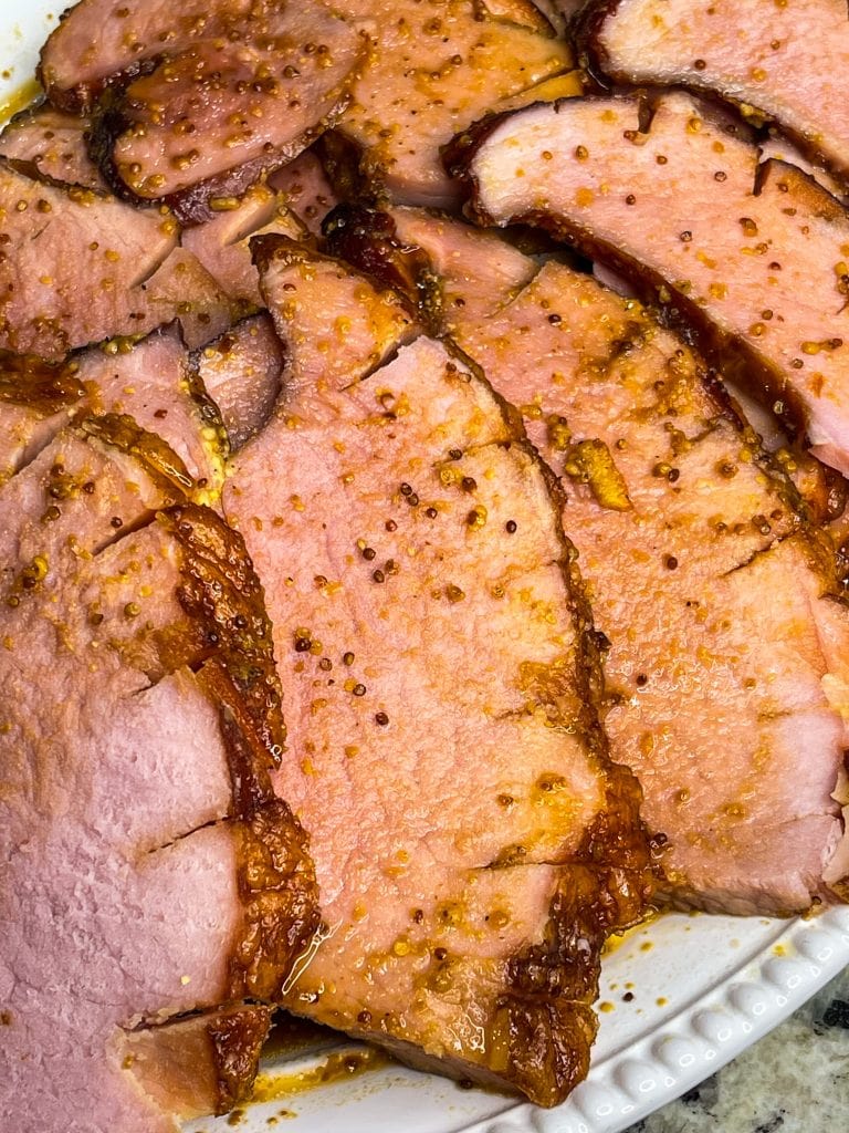 Easy and delicious, this slow cooker glazed ham is just 5 simple ingredients for a juicy ham dinner.