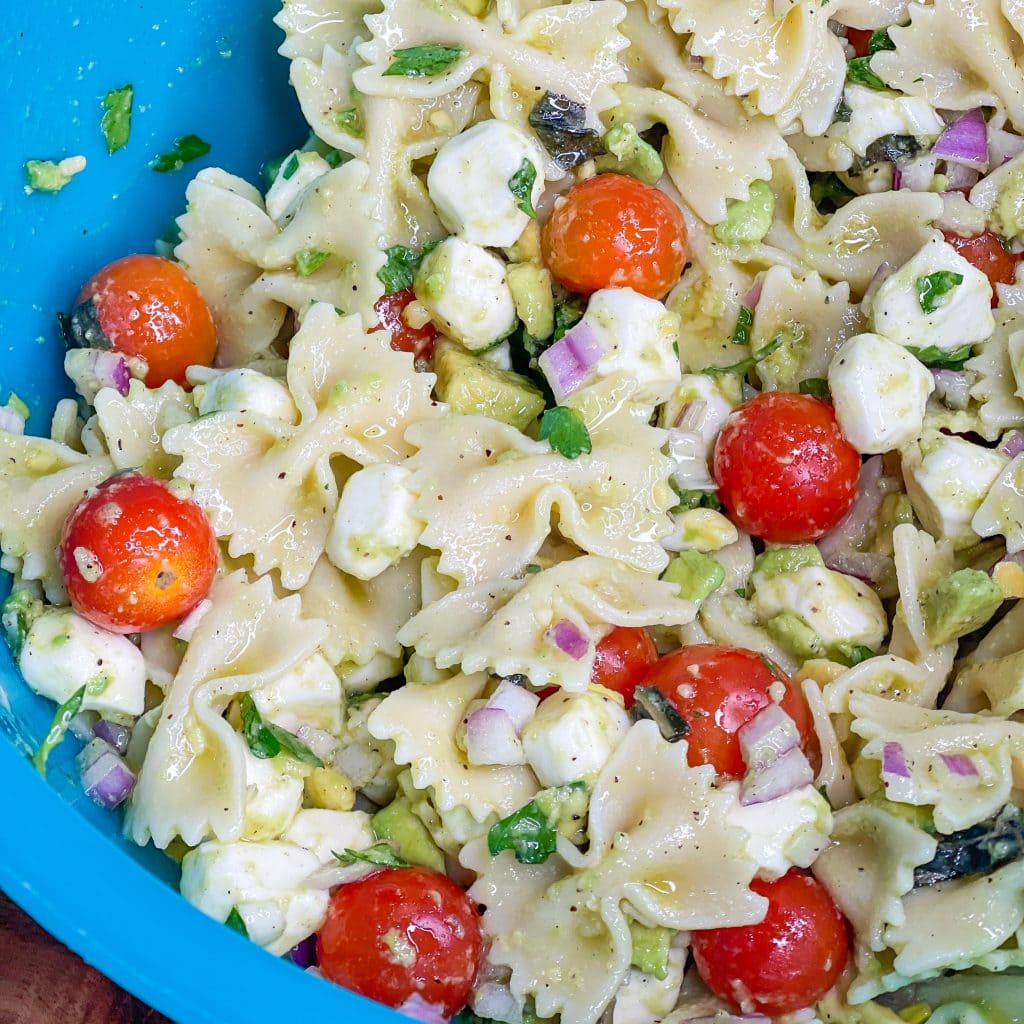 This pasta salad is one of my favorites! I really could eat it every day in the summer. Tender pasta, juicy tomatoes, fresh mozzarella, zesty red onion, and basil are coated in a creamy avocado vinaigrette. This pasta salad has all the flavors of summer.