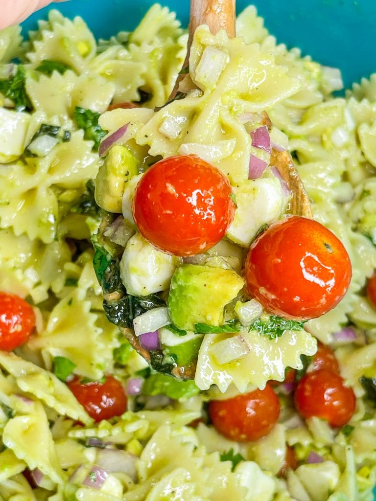 This pasta salad is one of my favorites! I really could eat it every day in the summer. Tender pasta, juicy tomatoes, fresh mozzarella, zesty red onion, and basil are coated in a creamy avocado vinaigrette. This pasta salad has all the flavors of summer.