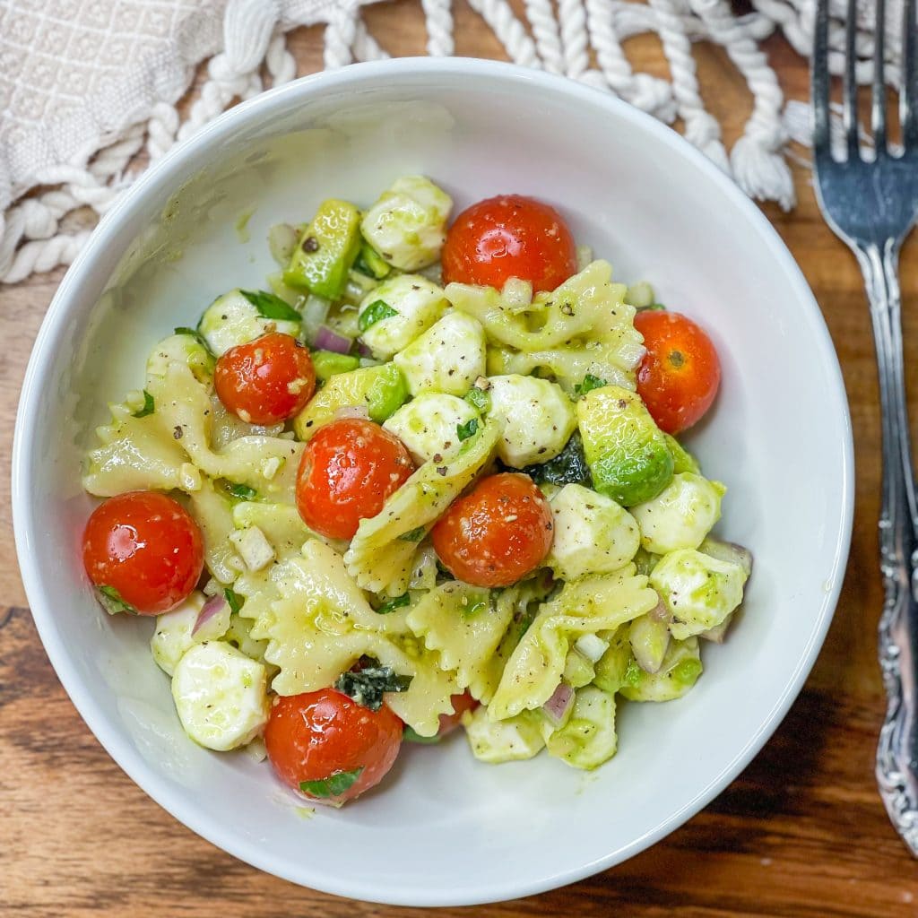 This pasta salad is one of my favorites! I really could eat it every day in the summer. Tender pasta, juicy tomatoes, fresh mozzarella, zesty red onion, and basil are coated in a creamy avocado vinaigrette. This pasta salad has all the flavors of summer.