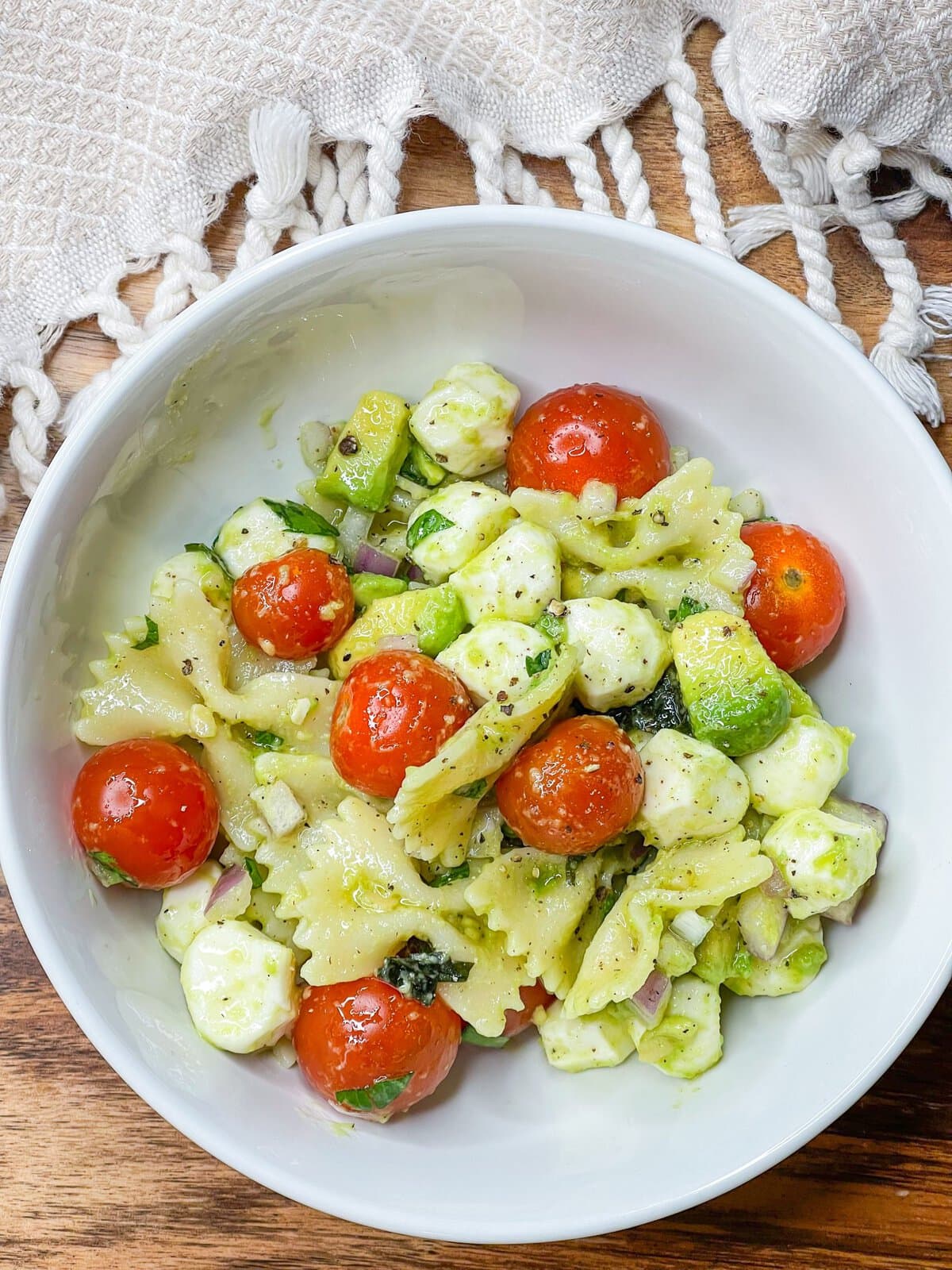 This pasta salad is one of my favorites! I really could eat it every day in the summer. Tender pasta, juicy tomatoes, fresh mozzarella, zesty red onion, and basil are coated in a creamy avocado vinaigrette. This pasta salad has all the flavors of summer.