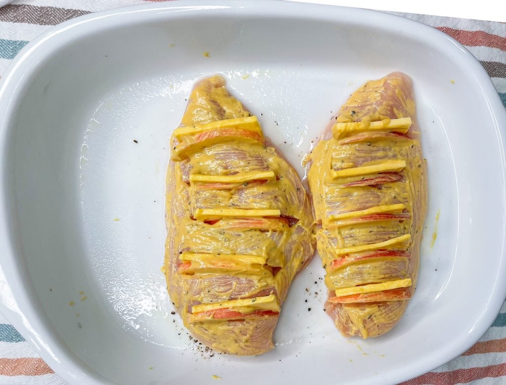 Hasselback chicken is so easy to make, but it looks so fancy! It's chicken breast cut hasselback style, then stuffed with the perfect pairing of gouda cheese and sliced gala apples. But it doesn't stop there! The chicken is topped with a panko breadcrumb mixture and when baked gives the chicken a nice crunch in every bite.