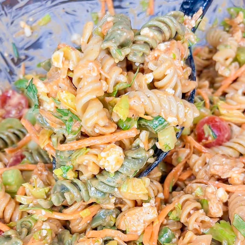 Buffalo Chicken Pasta Salad is spicy and cool with a creamy buffalo ranch sauce mixed with crunchy carrots and celery with a bite of blue cheese. Perfect for any summer occasion. 