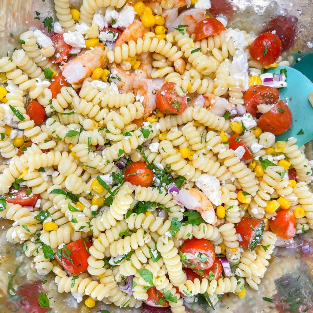 This quick and easy Creamy Shrimp Pasta Salad, with shrimp, veggies, pasta, and an avocado dressing, is the perfect pairing for any occasion.