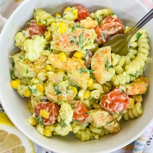 This quick and easy Creamy Shrimp Pasta Salad, with shrimp, veggies, pasta, and an avocado dressing, is the perfect pairing for any occasion.