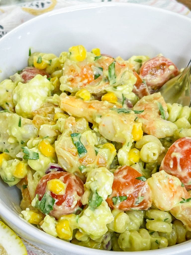 This quick and easy Creamy Shrimp Pasta Salad, with shrimp, veggies, pasta, and an avocado dressing, is the perfect pairing for any occasion.