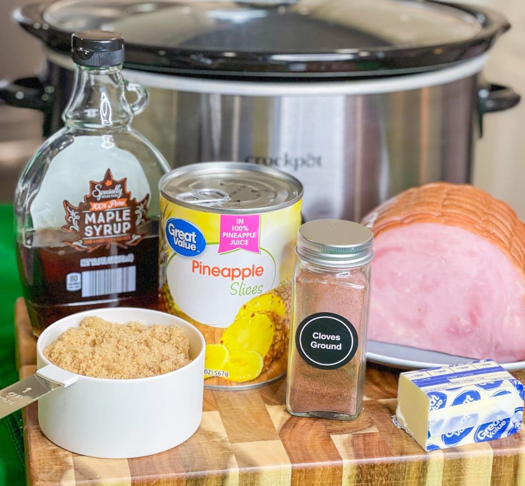 This slow cooked ham is just 6 simple ingredients; a boneless or bone-in spiral ham, brown sugar, canned pineapple, maple syrup, butter and a dash of cloves. Plus, it's a dump-and-go recipe, minimal effort and little clean up required. That is my type of meal!