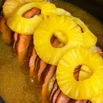 This slow cooked ham is just 6 simple ingredients; a boneless or bone-in spiral ham, brown sugar, canned pineapple, maple syrup, butter and a dash of cloves. Plus, it's a dump-and-go recipe, minimal effort and little clean up required. That is my type of meal!