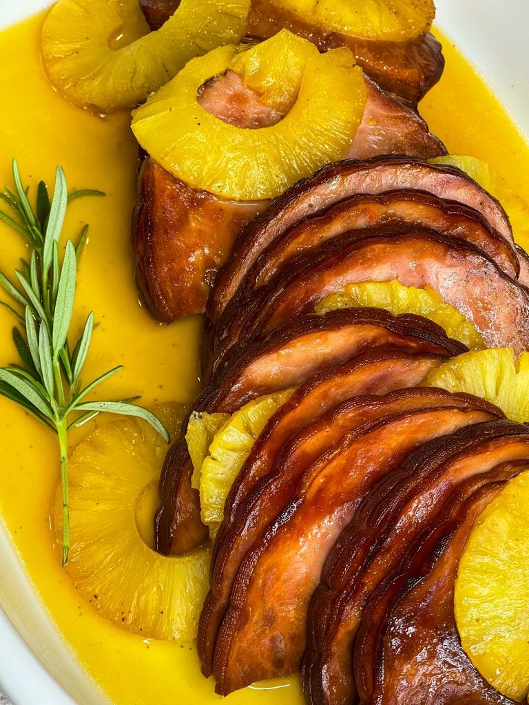 This slow cooked ham is just 6 simple ingredients; a boneless or bone-in spiral ham, brown sugar, canned pineapple, maple syrup, butter and a dash of cloves. Plus, it's a dump-and-go recipe, minimal effort and little clean up required. That is my type of meal!