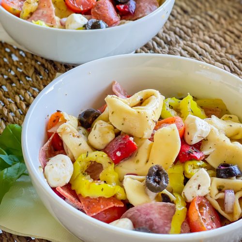 Love Italian subs? You will absolutely LOVE this Italian Sub Pasta Salad made with Italian meats, mozzarella cheese, tortellini, and veggies in an Italian vinaigrette. This pasta salad will make you the star of any get-together.