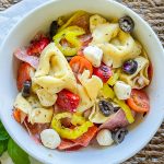 Love Italian subs? You will absolutely LOVE this Italian Sub Pasta Salad made with Italian meats, mozzarella cheese, tortellini, and veggies in an Italian vinaigrette. This pasta salad will make you the star of any get-together.