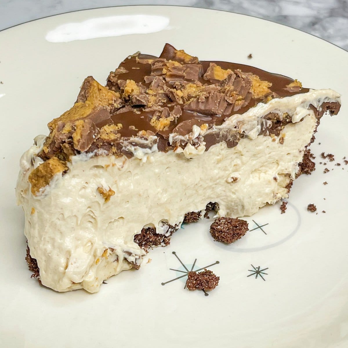 Just a few simple ingredients to this mouth-watering chocolate and peanut butter pie with a Reese's Peanut Butter Cups topping. And it's quick! If you are a fan of chocolate and peanut butter together, this is a must make! The perfect chilled pie for any occasion.