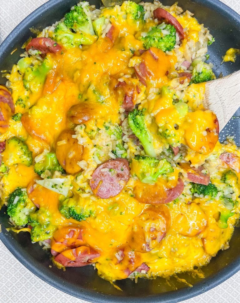 Skillet Kielbasa is an easy, full meal made in one pan and ready in just 30 minutes. It's made with rice, kielbasa, chicken broth, broccoli, and topped with cheddar cheese. Perfect for a busy weeknight.