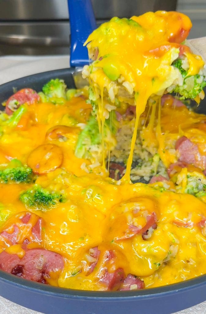 Skillet Kielbasa is an easy, full meal made in one pan and ready in just 30 minutes. It's made with rice, kielbasa, chicken broth, broccoli, and topped with cheddar cheese. Perfect for a busy weeknight.