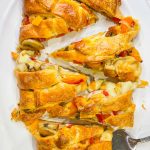 This Cheesesteak Crescent Roll Braid is perfect for any party, on game day, or for an easy weeknight dinner. It starts with a sheet of flaky crescent dough and is filled with roast beef, provolone cheese, horseradish sauce and sauteed veggies. A crowd pleaser, for sure!